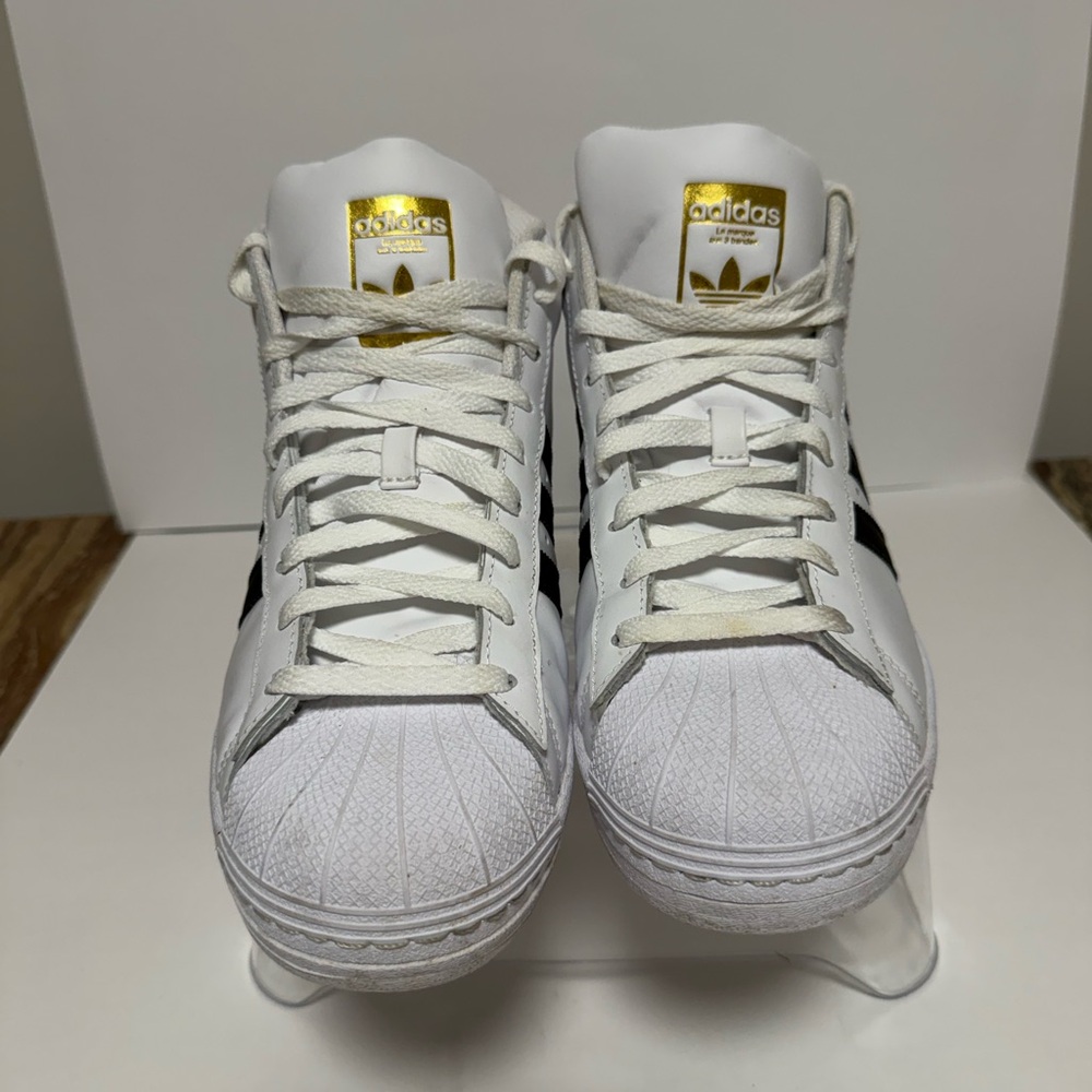 Adidas White Sneakers with Black Stripes and Gold Accents